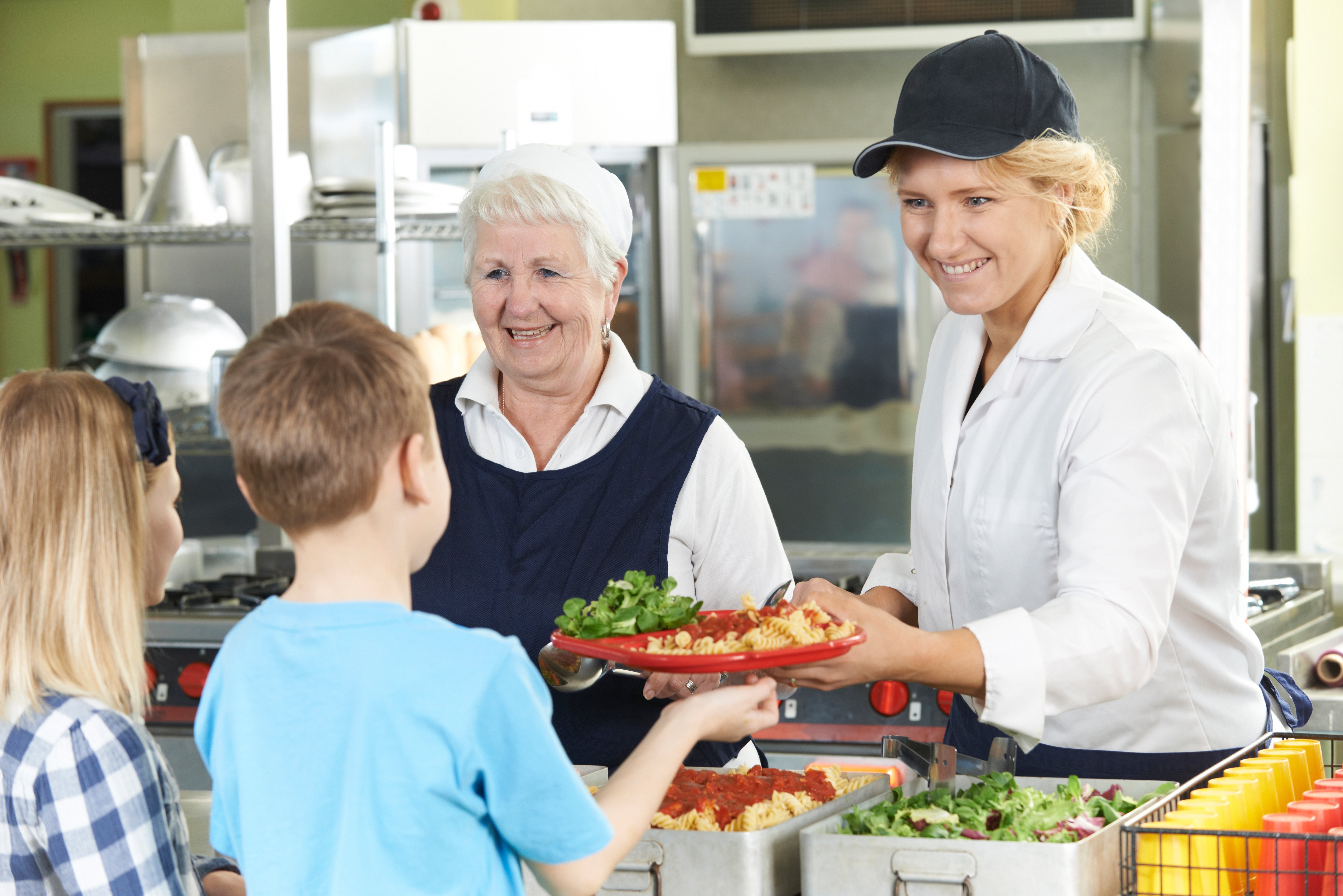 Cafeteria worker serving student